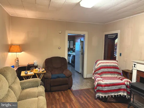 a room with table chairs and wooden floor