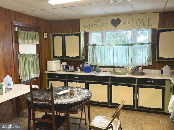 a kitchen with a table chairs stove and sink