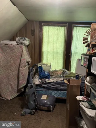 a bedroom with bed and flat screen tv