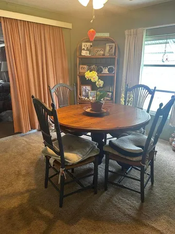 a dining room with furniture and window