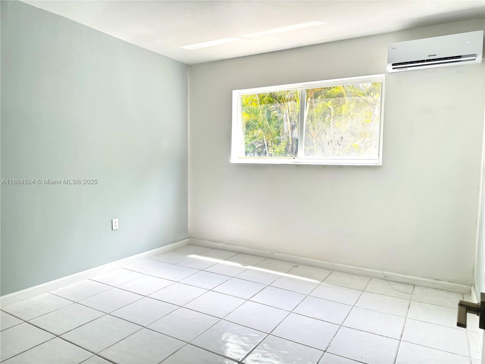 6310 Southwest 79th Street, Unit 2 South Miami, FL 33143 - Photo 2 of 8 a view of an empty room and window