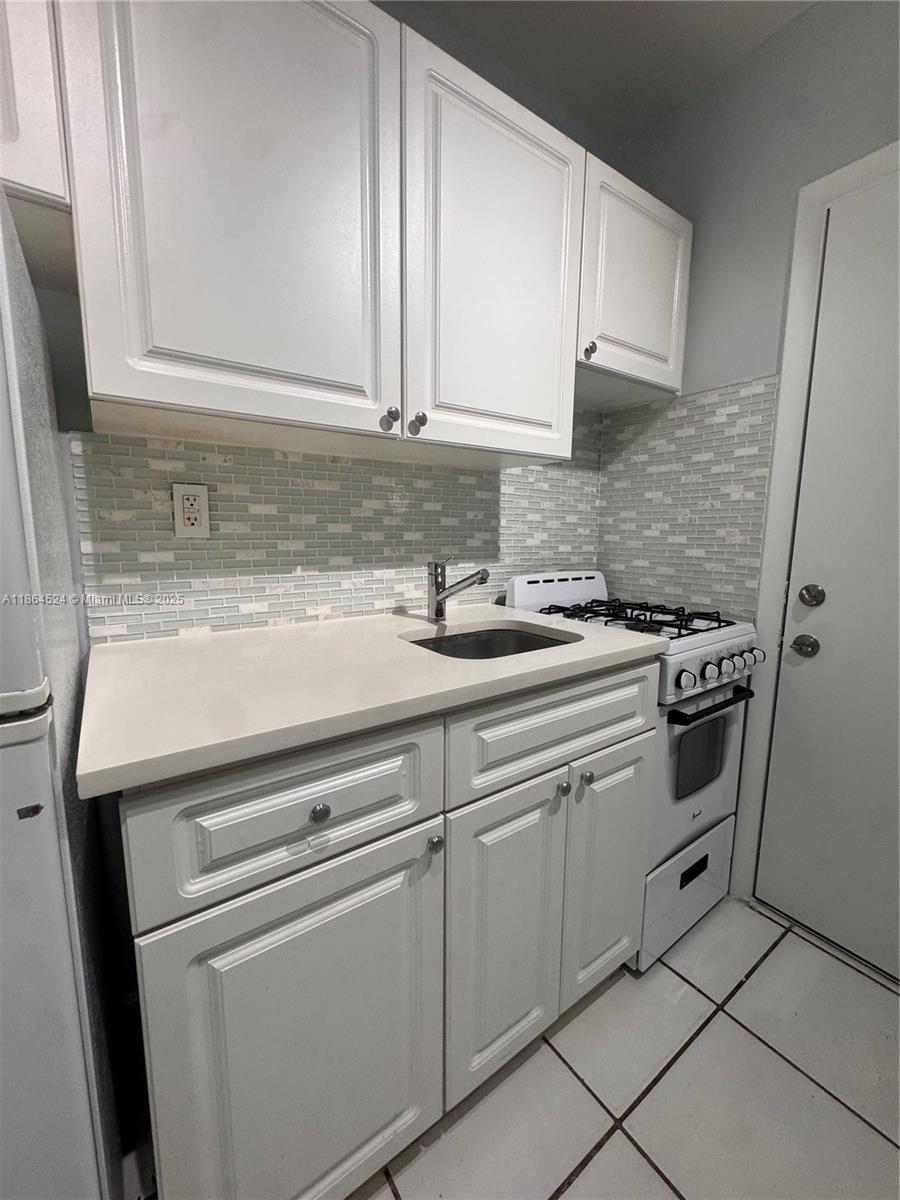 6310 Southwest 79th Street, Unit 2 South Miami, FL 33143 - Photo 4 of 8 a kitchen with appliances cabinets and a counter top space