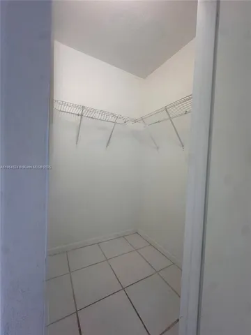 a spacious bathroom with a toilet a sink and mirror