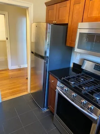 a stove top oven sitting inside of a kitchen