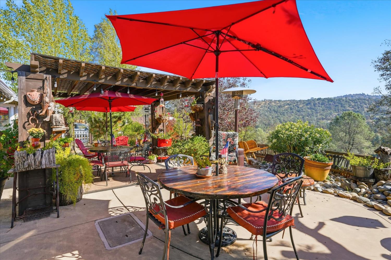 a view of a patio with a table and chairs under an umbrella