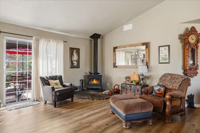 a dining room filled chandelier and kitchen view
