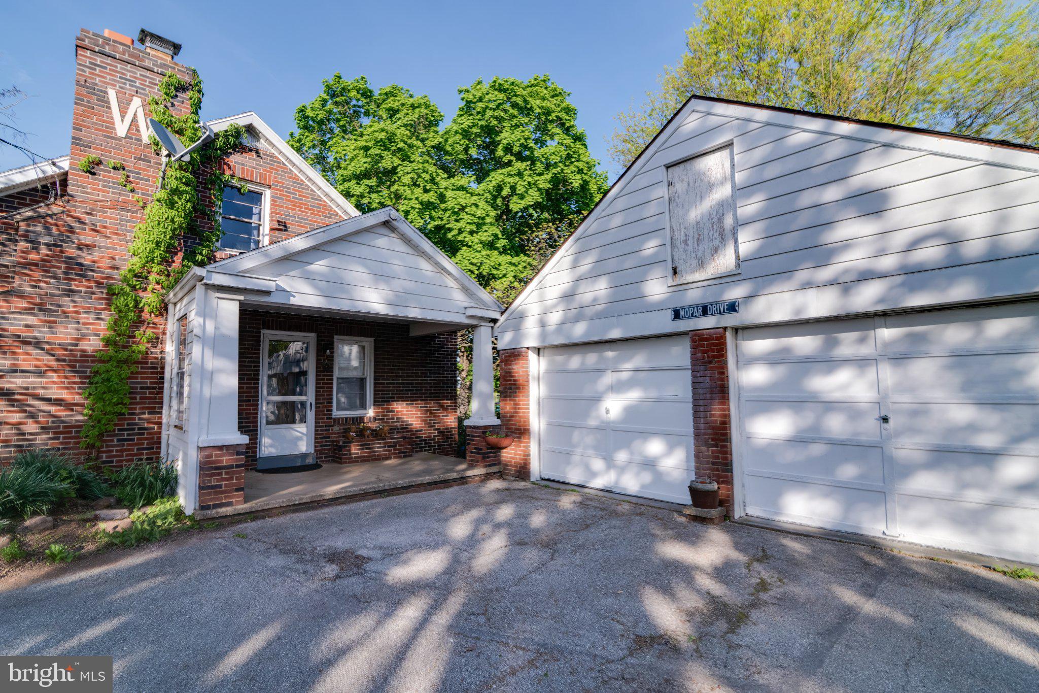 4330 Paradise Road Dover, PA 17315 - Photo 2 of 23 Charming brick home with lush greenery.