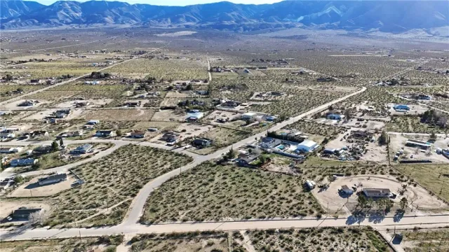 an aerial view of residential house and sandy dunes