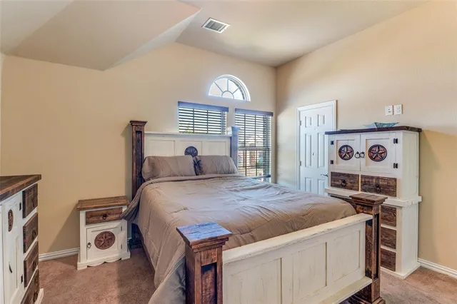 a bed room with a bed and a tv