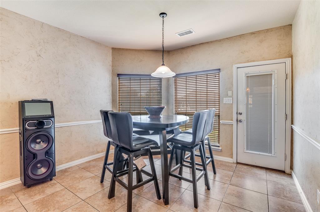 1512 Ruffian Road DeSoto, TX 75115 - Photo 17 of 25 a view of a dining room with furniture and chandelier