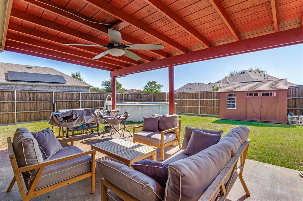 1512 Ruffian Road DeSoto, TX 75115 - Photo 18 of 25 a view of a patio with a table and chairs