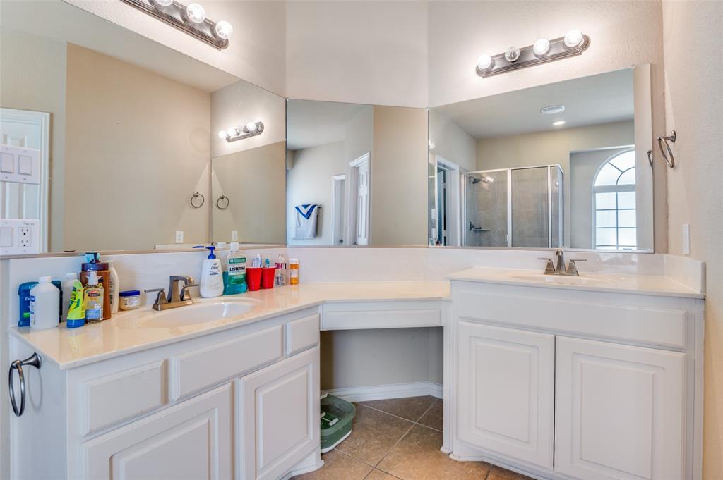 1512 Ruffian Road DeSoto, TX 75115 - Photo 20 of 25 a bathroom with a sink vanity and a mirror