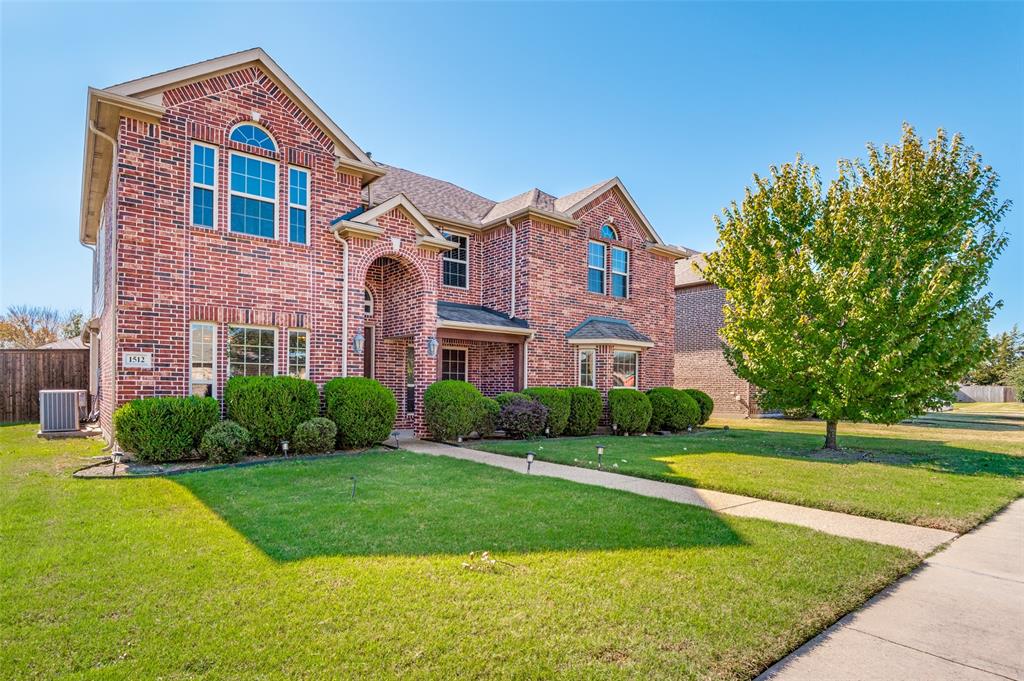 1512 Ruffian Road DeSoto, TX 75115 - Photo 2 of 25 a front view of a house with garden