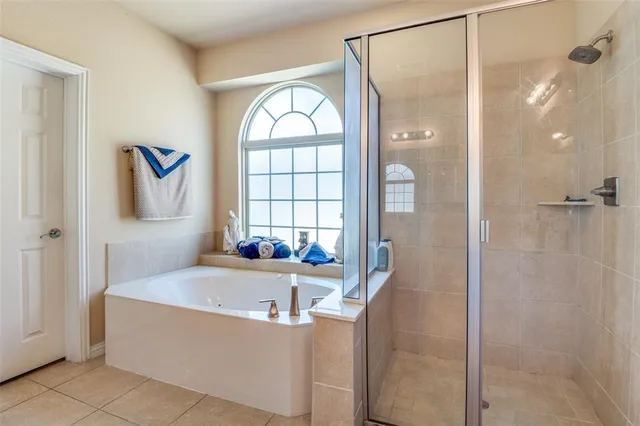 a bathroom with a bathtub and a shower