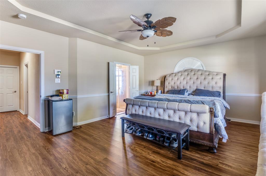 1512 Ruffian Road DeSoto, TX 75115 - Photo 22 of 25 a bedroom with a bed and a chandelier