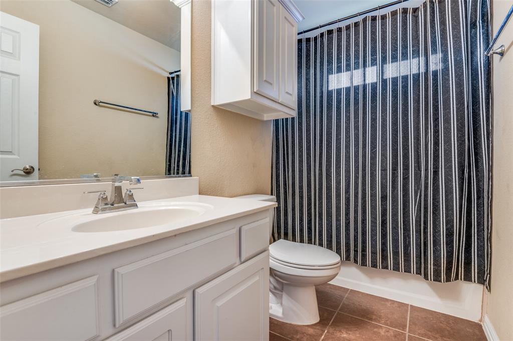 1512 Ruffian Road DeSoto, TX 75115 - Photo 23 of 25 a bathroom with a sink a toilet and mirror