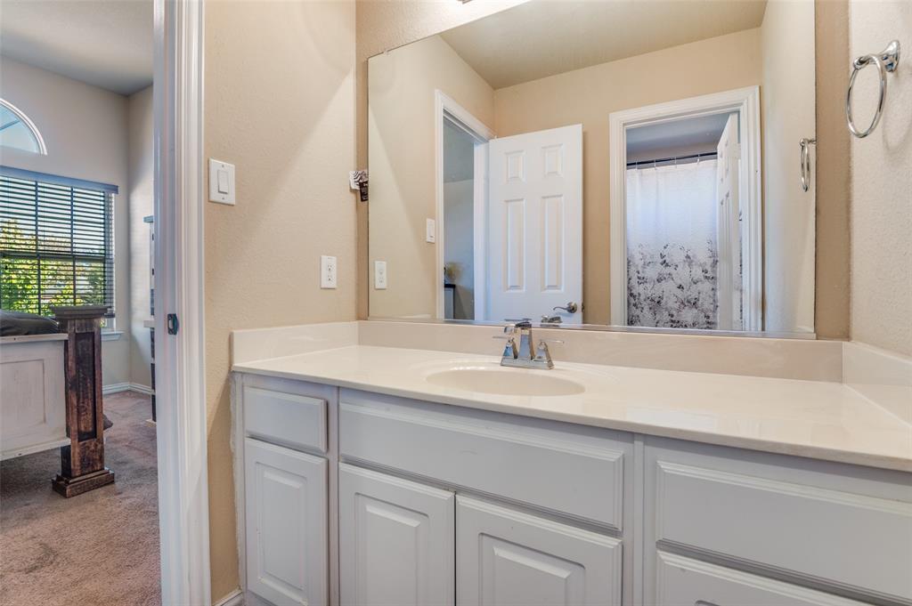 1512 Ruffian Road DeSoto, TX 75115 - Photo 24 of 25 a bathroom with a sink and a mirror
