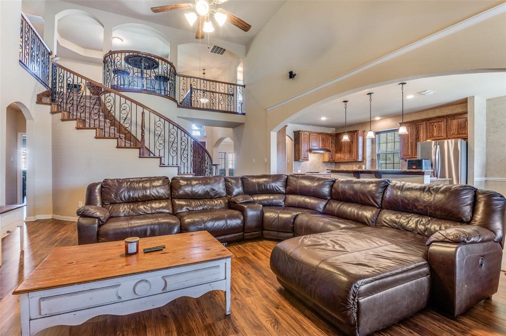 1512 Ruffian Road DeSoto, TX 75115 - Photo 4 of 25 a living room with furniture and a chandelier