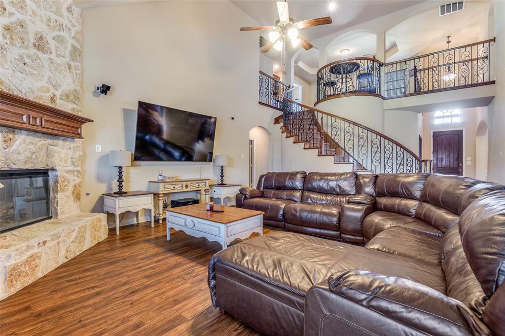 1512 Ruffian Road DeSoto, TX 75115 - Photo 5 of 25 a living room with furniture flat screen tv and a fireplace
