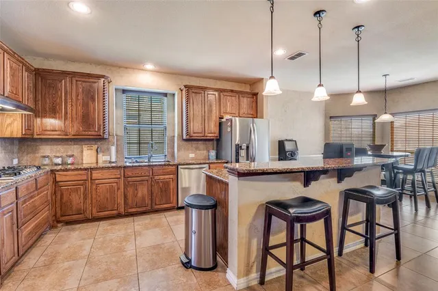 a kitchen with sink cabinets and dining table