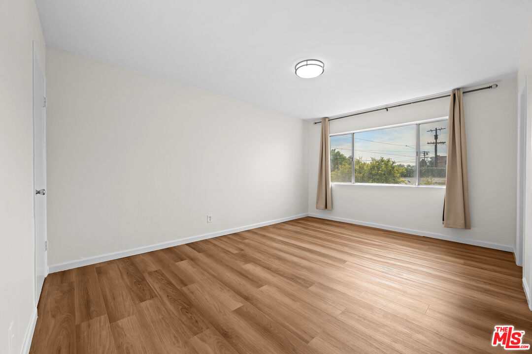 1206 South Holt Avenue, Unit 2 Los Angeles, CA 90035 - Photo 11 of 17 a view of empty room with wooden floor and fan