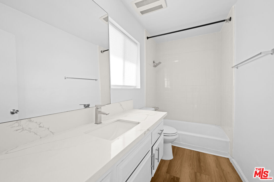 1206 South Holt Avenue, Unit 2 Los Angeles, CA 90035 - Photo 13 of 17 a bathroom with a sink a toilet and a shower