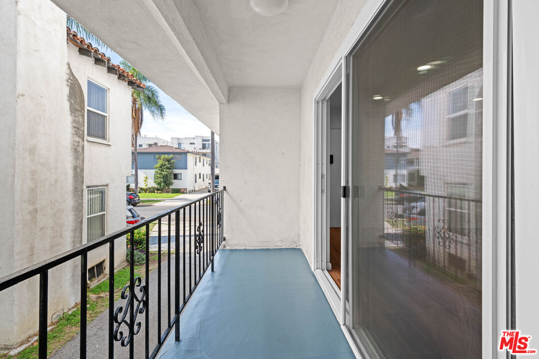 1206 South Holt Avenue, Unit 2 Los Angeles, CA 90035 - Photo 16 of 17 a view of a hallway with wooden floor and windows