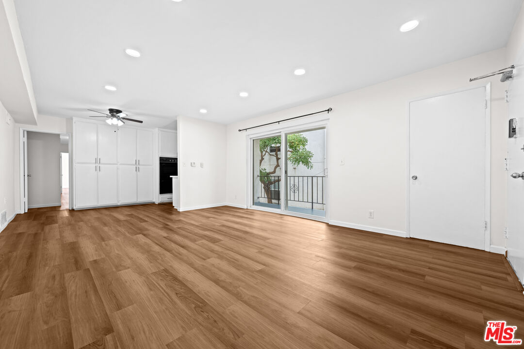 1206 South Holt Avenue, Unit 2 Los Angeles, CA 90035 - Photo 4 of 17 a view of empty room with wooden floor and fan