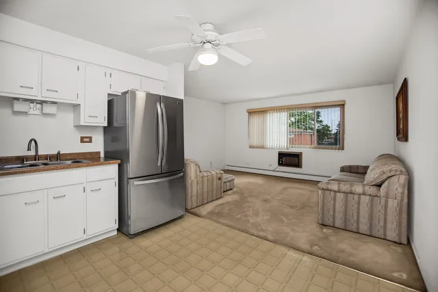 a kitchen with stainless steel appliances granite countertop a refrigerator sink and cabinets