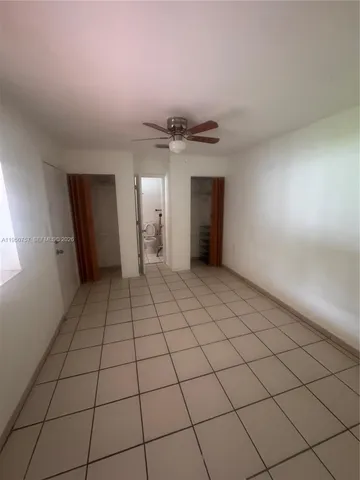 a view of an empty room and a window