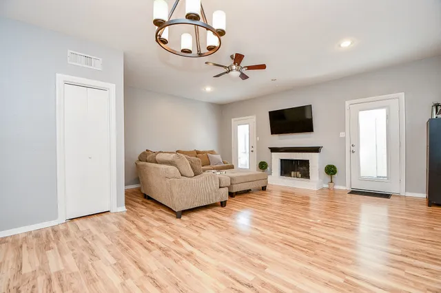 a living room with furniture a fireplace and a flat screen tv