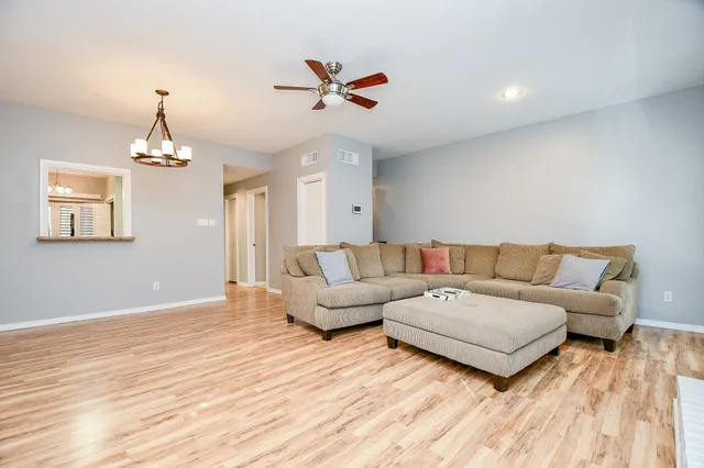 a living room with furniture and a chandelier
