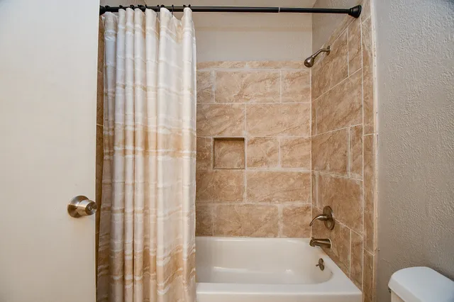 a bathroom with a shower curtain