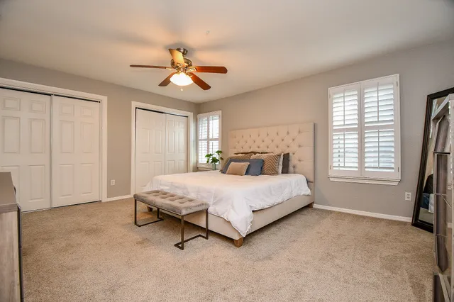 a spacious bedroom with a bed and a window