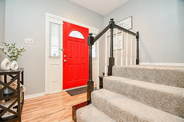 a living room with furniture a dining table and a entryway