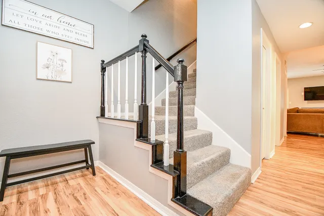 a view of entryway and hall with wooden floor