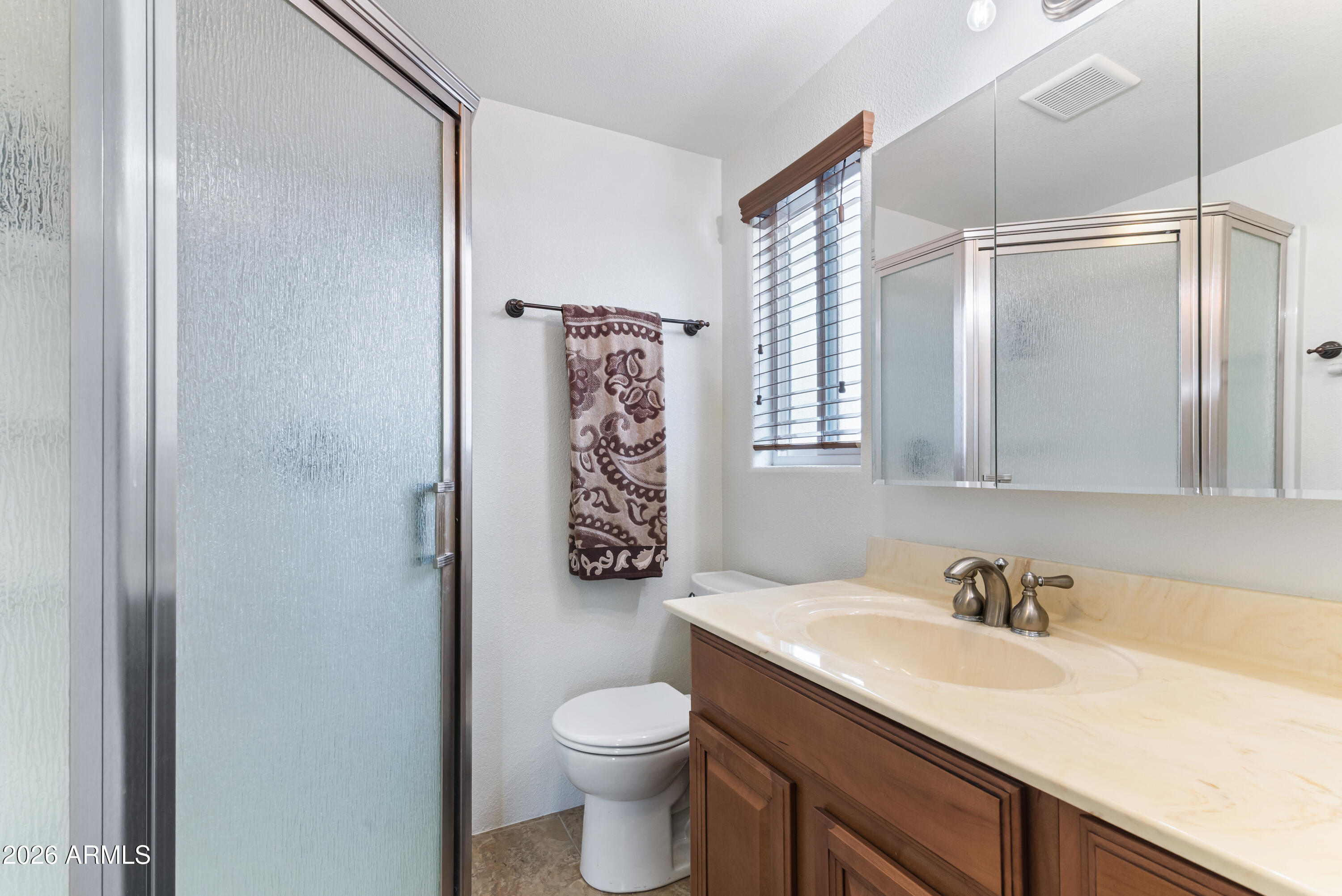 111 South Greenfield Road, Unit 547 Mesa, AZ 85206 - Photo 28 of 38 a bathroom with a granite countertop sink toilet and shower