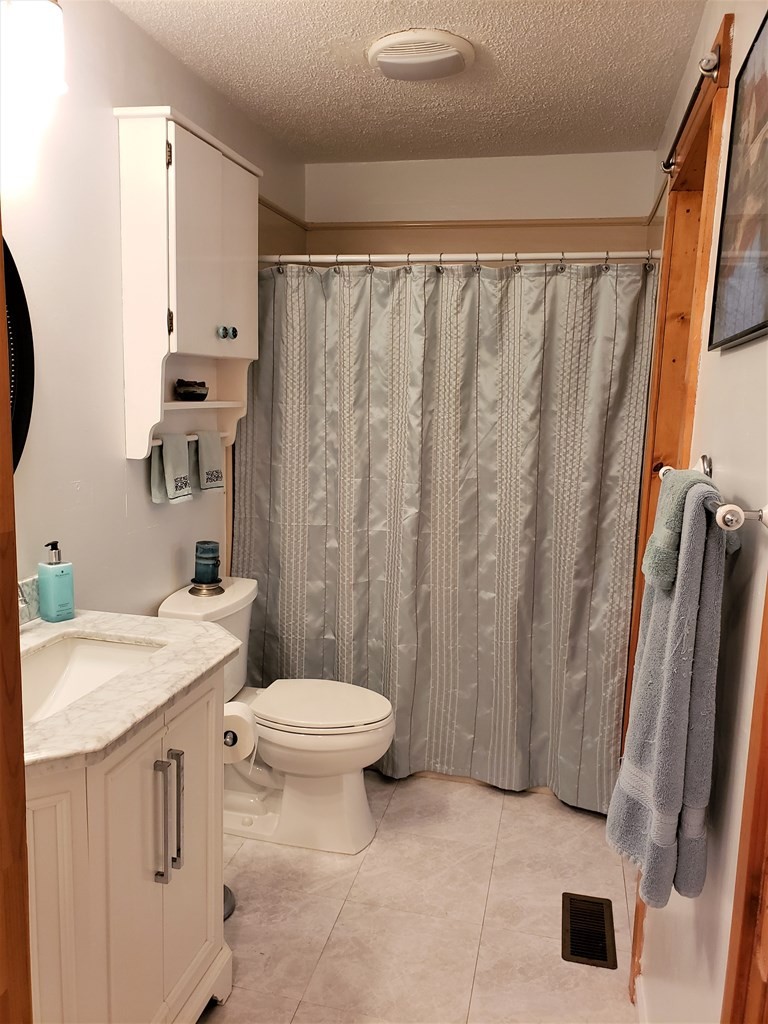 375 Todd Road Southeast Cleveland, TN 37323 - Photo 30 of 47 a bathroom with a sink a toilet a mirror and shower curtain