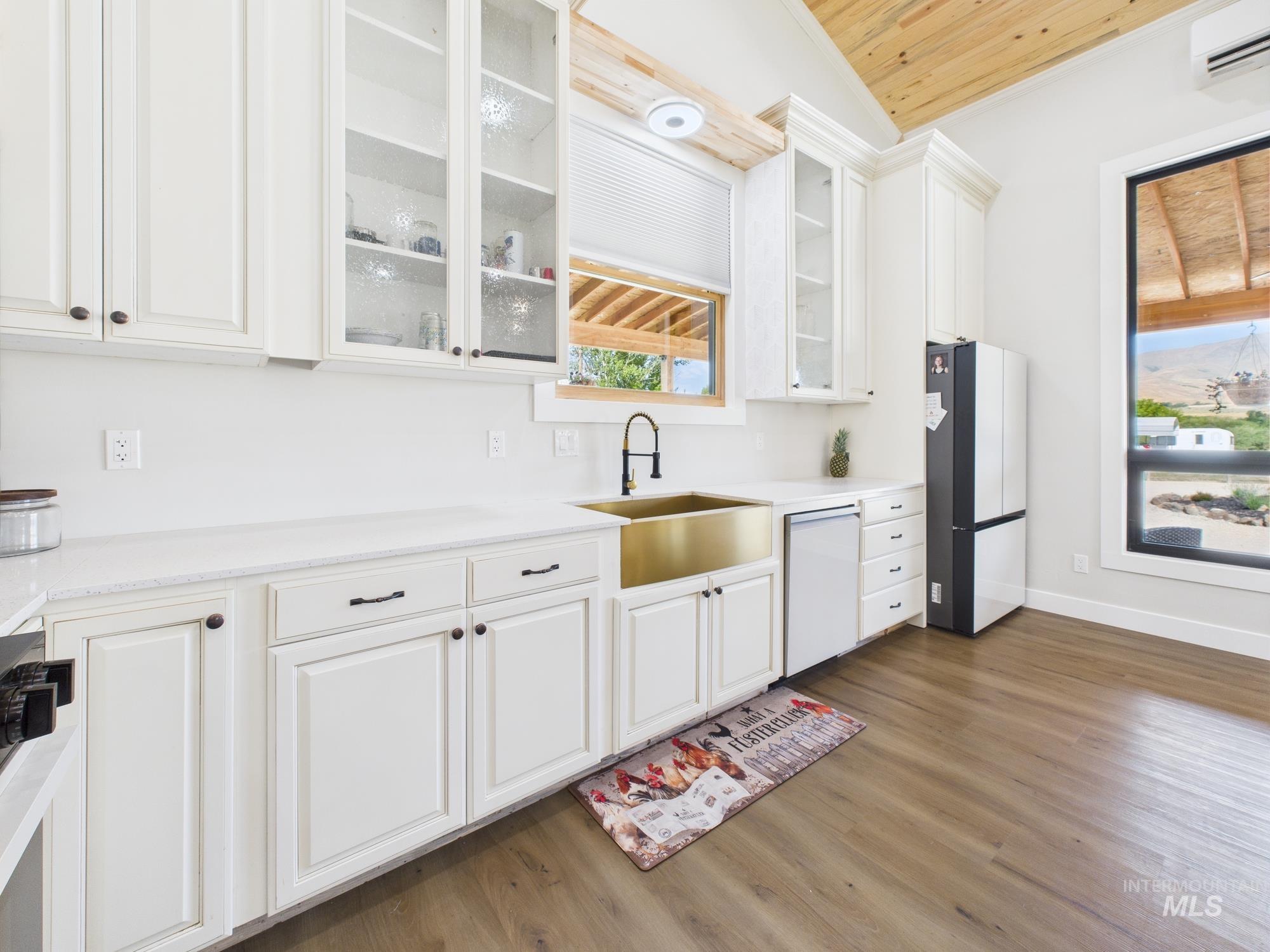 6501 Sweet Ola Highway Sweet, ID 83670 - Photo 9 of 43 Kitchen featuring wood finished floors, white cabinetry, freestanding refrigerator, light countertops, and wood ceiling