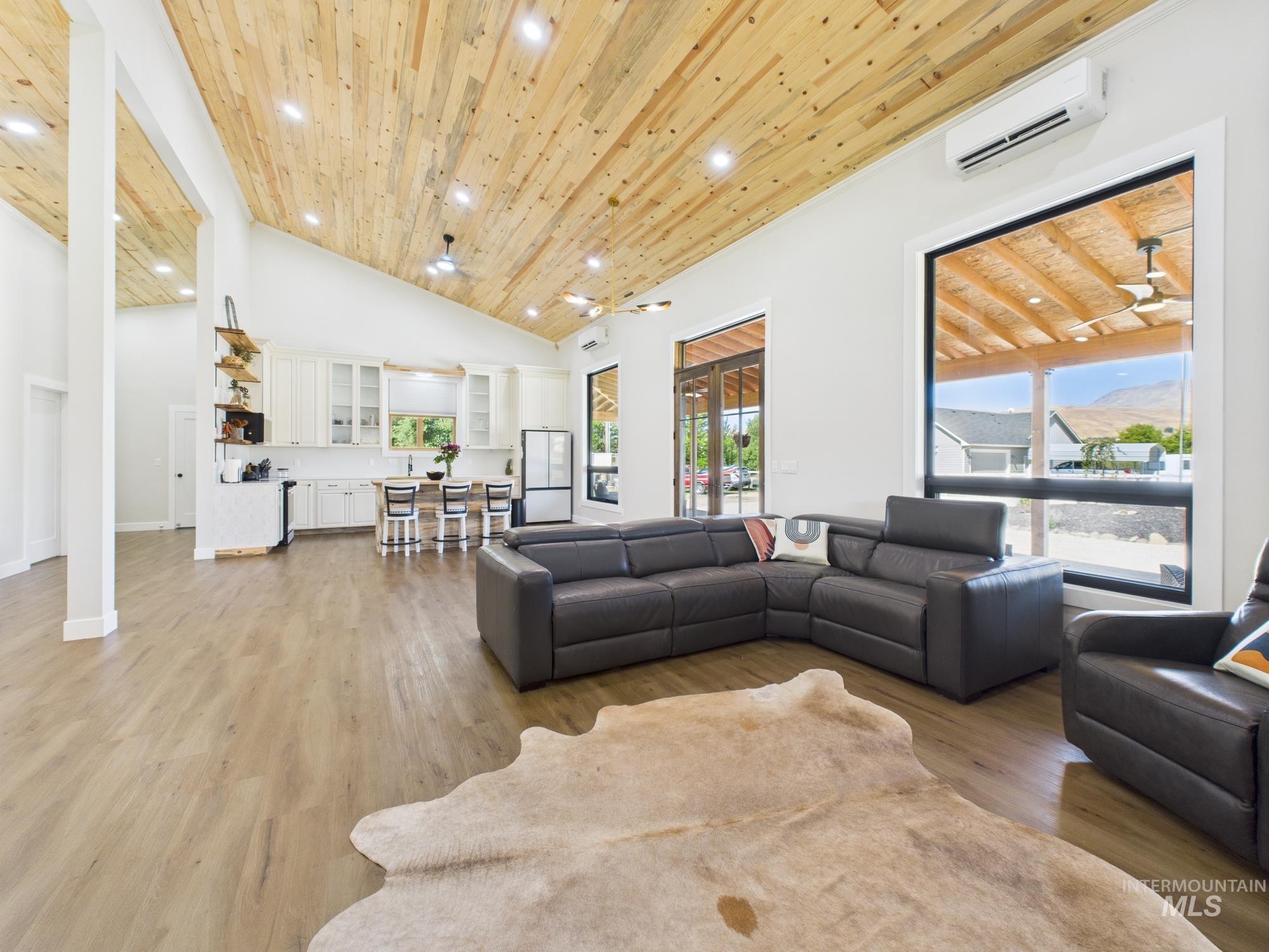 6501 Sweet Ola Highway Sweet, ID 83670 - Photo 13 of 43 Living room with wood ceiling, light wood-type flooring, high vaulted ceiling, a wall mounted AC, and recessed lighting