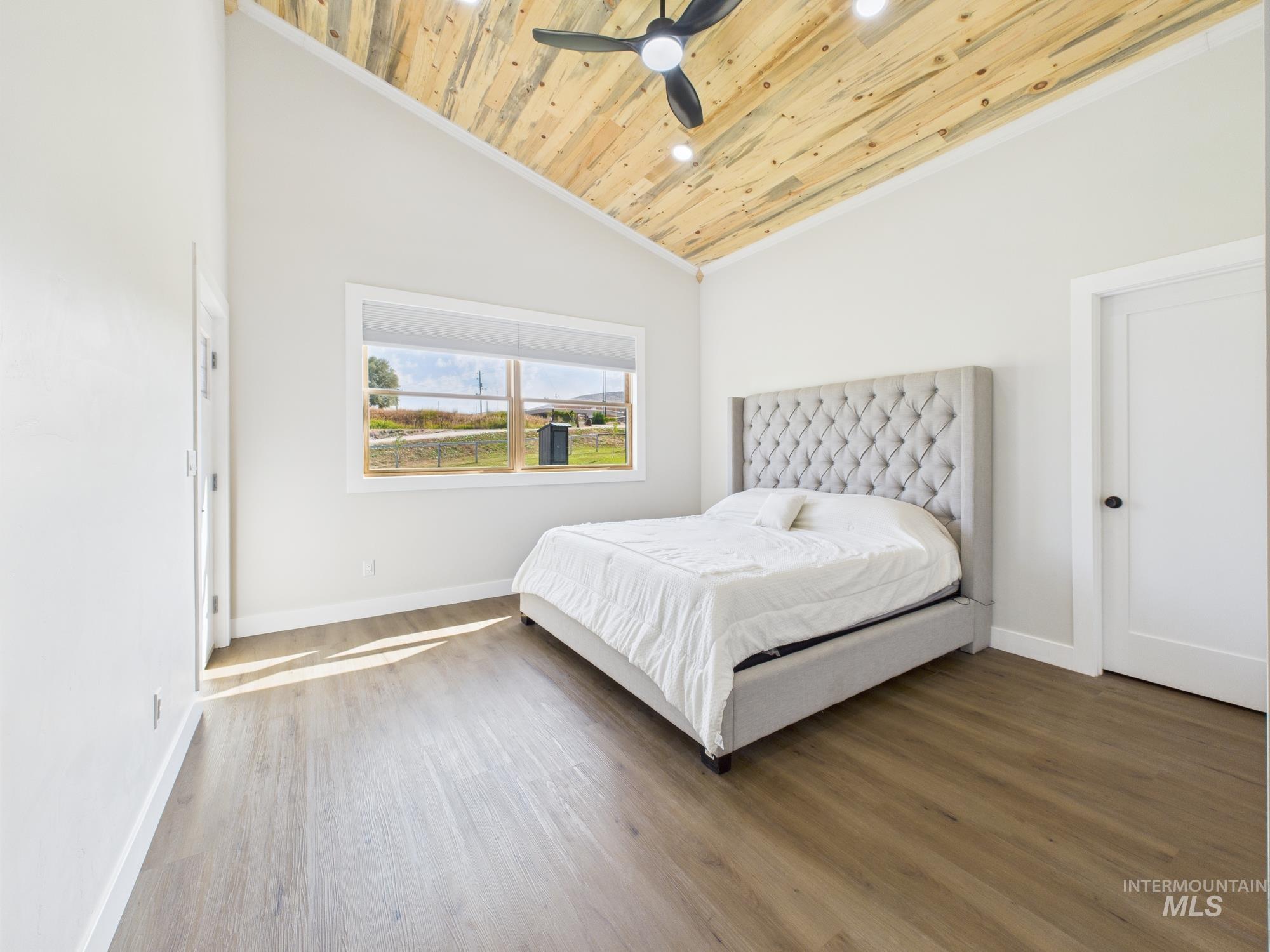 6501 Sweet Ola Highway Sweet, ID 83670 - Photo 18 of 43 Bedroom with ornamental molding, wooden ceiling, wood finished floors, ceiling fan, and high vaulted ceiling