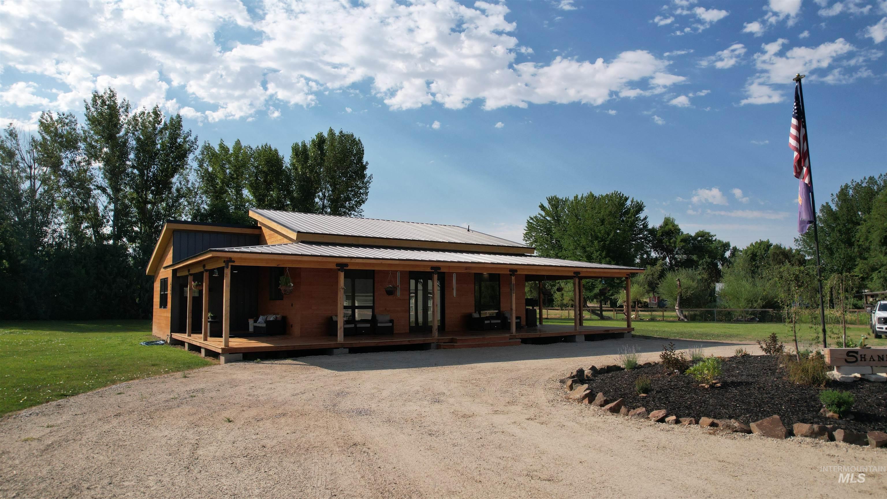6501 Sweet Ola Highway Sweet, ID 83670 - Photo 39 of 43 Farmhouse featuring a metal roof, covered porch, a front lawn, and driveway