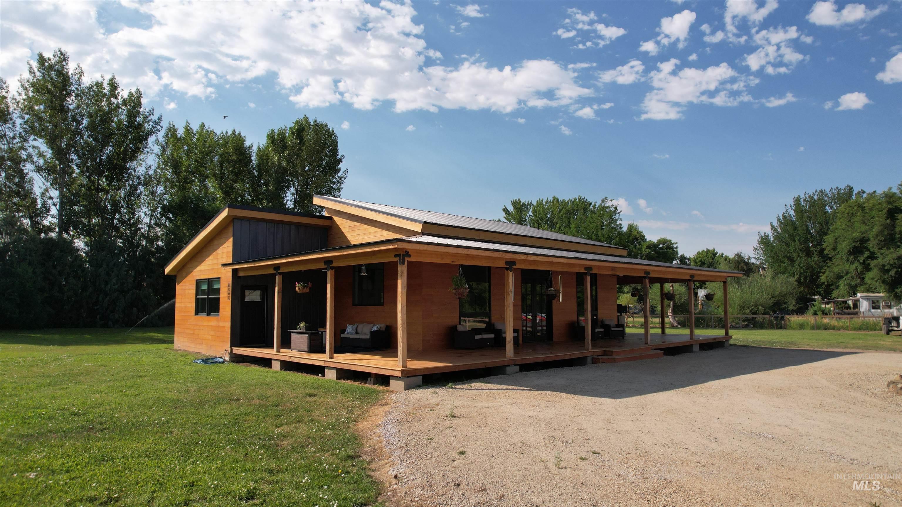 6501 Sweet Ola Highway Sweet, ID 83670 - Photo 40 of 43 View of front of property featuring a front yard, a wooden deck, and dirt driveway