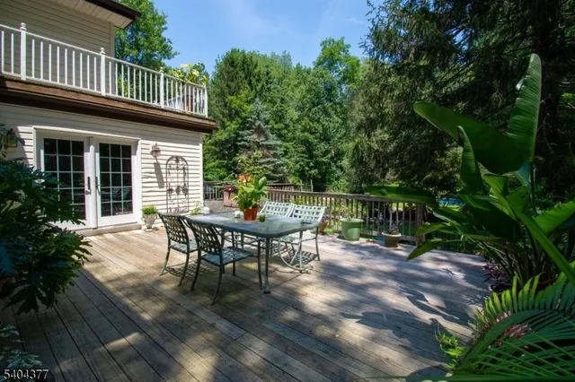 a view of a house with a deck and furniture