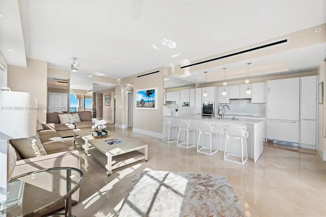 a kitchen with kitchen island a counter top space a sink stainless steel appliances and cabinets