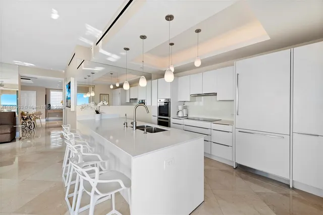 a dining room with furniture a chandelier and wooden floor