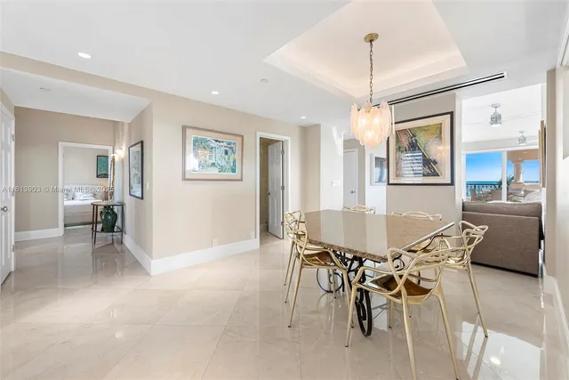 a bedroom with a bed and large windows