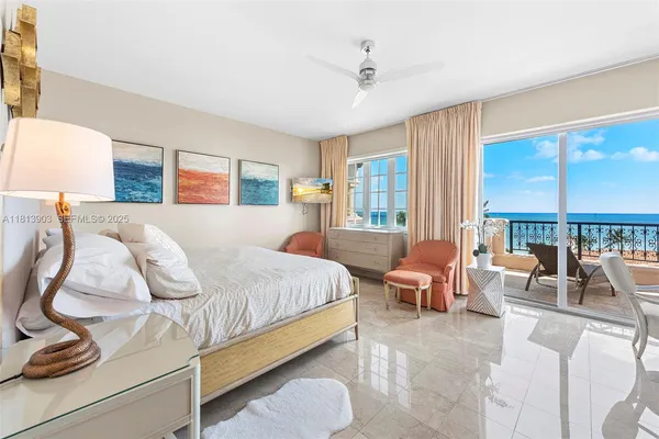 a bedroom with furniture and large windows