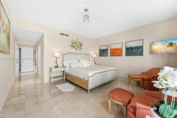 a bedroom with a bed window and couch