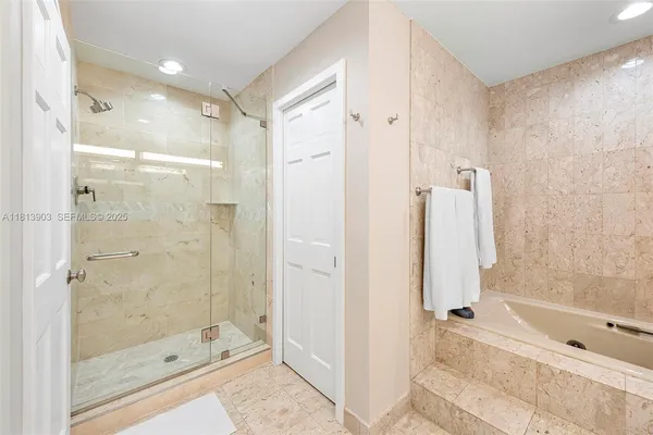 a bathroom with a shower and a tub